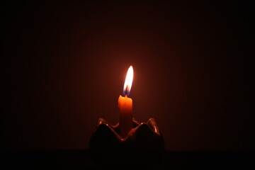 burning candle in the dark