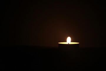 burning candle in the dark