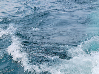 Surface view of blue Lake Michigan water with a small wave  