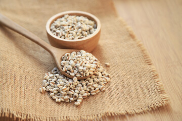 Fresh organic millet or job's tear seed on sack in bowl  in kitchen for cooking in daily life meal. selective focus. top view.