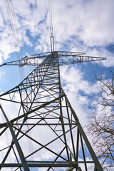 A High voltage pole with blue white sky