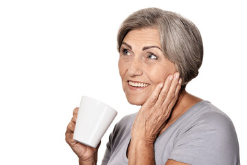 beautiful smiling senior woman drinking tea isolated on white
