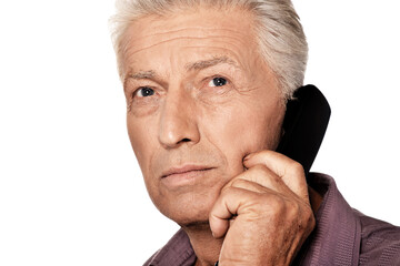 Senior man calling  phone on white