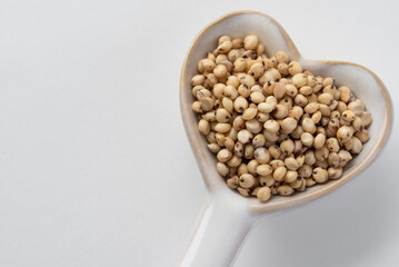 Sorghum Seeds on a Heart Shaped Spoon