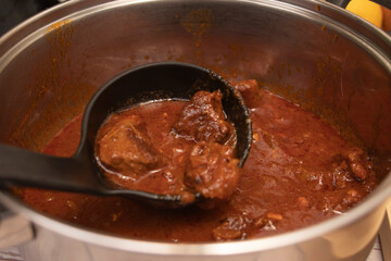 Fototapeta premium A saucepan of goulash, ready to serve. Traditional foods concept.