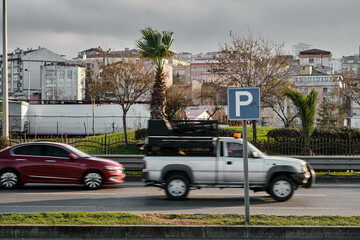 Fototapeta premium Selective focus photo, motion of cars and automobiles and Parking sign.