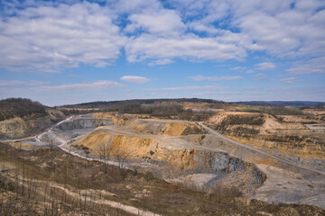 sunny illuminated stone pit scenery in Southern Germany with blue sky and clouds