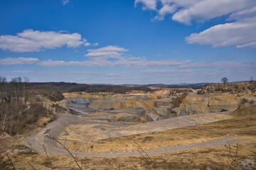 sunny illuminated stone pit scenery in Southern Germany with blue sky and clouds