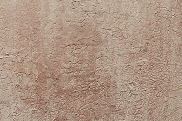 A plaster painted surface with cracks and damages. Concrete wall background with detailed texture.