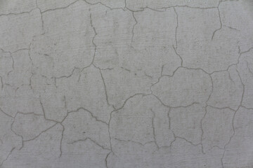 An old cement wall, abstract grey background. A cracked concrete wall texture with scratches.