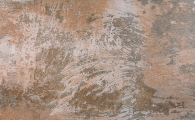 A plastered concrete surface with brush strokes. Brown painted wall background with detail texture.