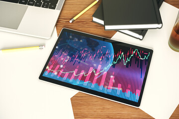 Modern digital tablet screen with abstract financial graph and world map, financial and trading concept. Top view. 3D Rendering