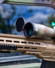 Sniper rifle with a telescopic sight for long range shooting in war.