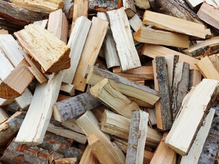 Preparation of firewood for the winter. firewood background, Stacks of firewood in the forest. Pile of firewood.