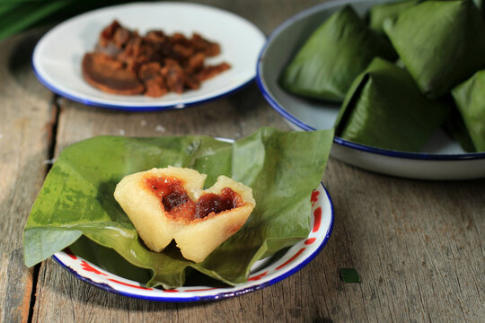 Kue Bugis or Kue Mendut, Indonesian traditional dessert made from glutinous rice flour, stuffed with sweet grated coconut, wrapped in banana leaf.