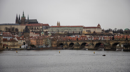 Obraz premium winter rainy day in Prague - view of Vltava river, Charles bridge and Prague castle
