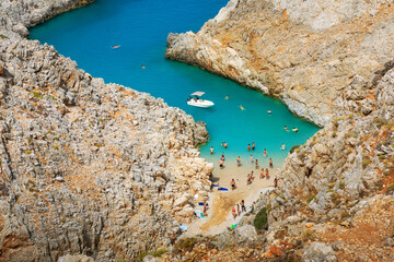 Magical view above Seitan Limania beach with tourists enjoying their day, Crete, Greece