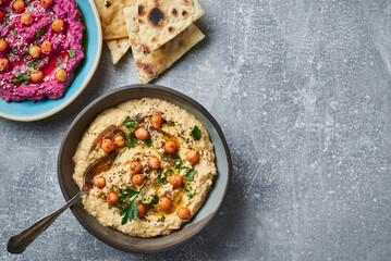 Vegan chickpea hummus with chia seeds and parsley.Traditional vegan chickpea hummus garnished with parsley olive oil and chia seeds. Vegan diet super food.