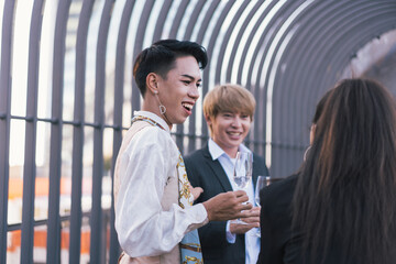Young business people toasting with each other and smiling while standing on rooftops