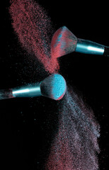 Make up brushes colliding and exploding with powder