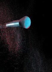 Make up brushes colliding and exploding with powder