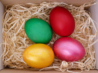 Fototapeta na wymiar Four easter eggs in a box.