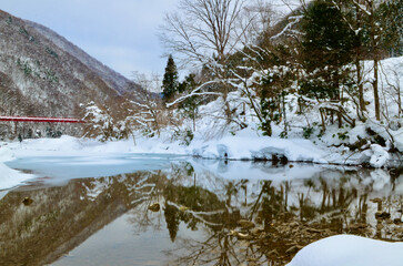 Beautiful snow scene and red bridge