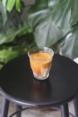 dirty coffee iced latte freeze milk pour espresso shot in a cup of coffee on scale measurement wooden bar table cafe in thailand asia by barista workout