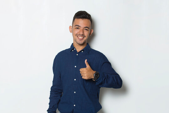 young handsome business man with ok sign gesture tumb up isolated on white background
