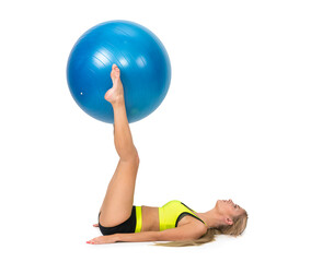 Fototapeta na wymiar A shapely woman is exercising with a rehabilitation ball