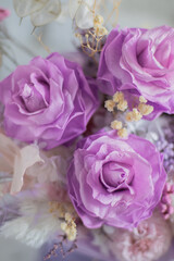 A mix of pink peonies with purple and pink roses on coffee table. Bouquet of tenders peonies a girl for mother's day, valentine's day, Woman's day 8 march.