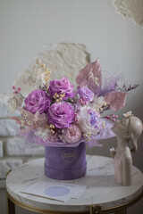 A mix of pink peonies with purple and pink roses on coffee table. Bouquet of tenders peonies a girl for mother's day, valentine's day, Woman's day 8 march.