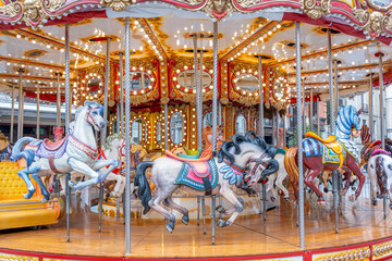 Fototapeta na wymiar Carousel of horses in festive days