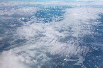 Overlooking of Mountains and Clouds . Snowy mountain range and cloudscape view from above 