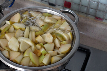 Freshly Chopped Apple Pieces Boiling in a Pot,Making Homemade Apple Juice,