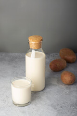 Potato milk setup with a sealed bottle and a filled glass, presenting a new alternative to dairy.