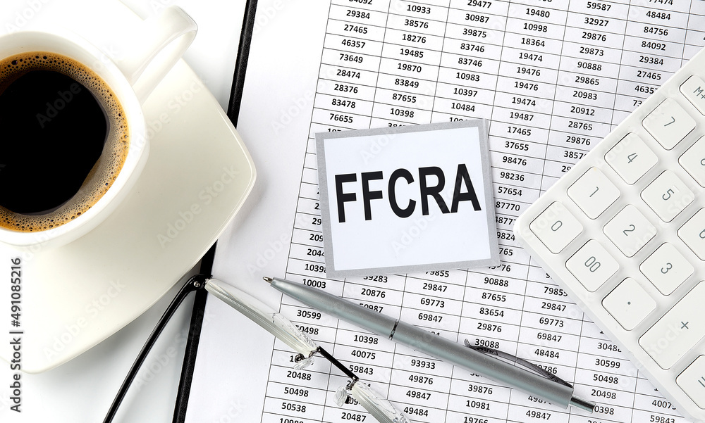 Poster ffcra text on sticky on chart with coffee,pen and calculator