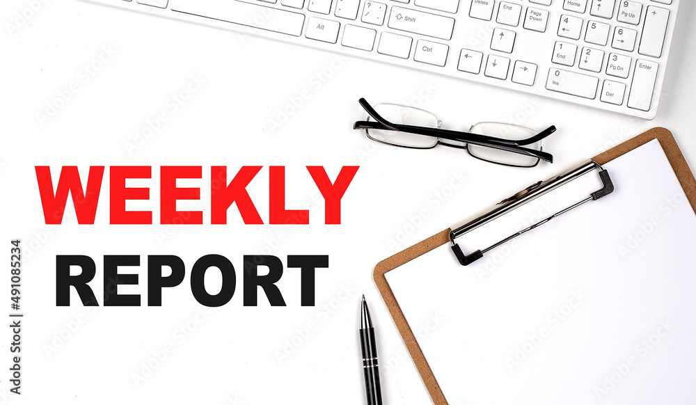 Poster weekly report text written on the white background with keyboard, paper sheet and pen