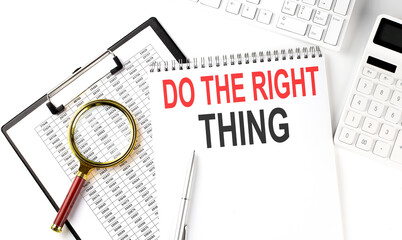 Office desk table with keyboard, notepad and calculator. Top view with text DO THE RIGHT THING