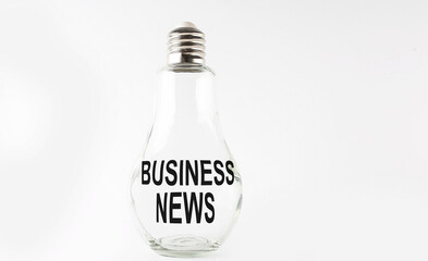 Text BUSINESS NEWS on the bulb on the white background. Business concept