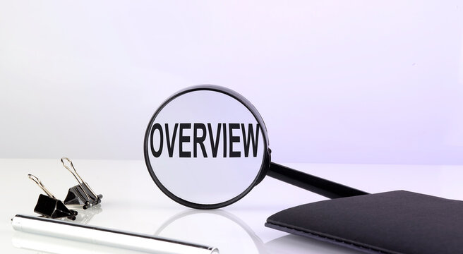 OVERVIEW text concept. Magnifier glass with text with notebook and pen,business