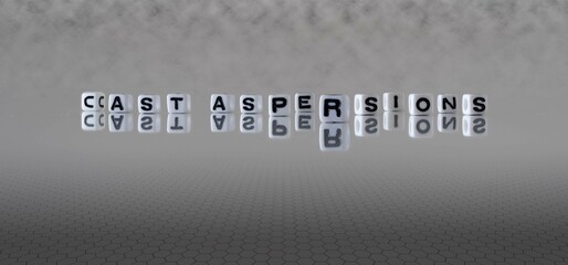 cast aspersions word or concept represented by black and white letter cubes on a grey horizon...