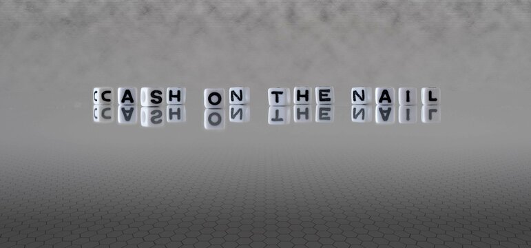 cash on the nail word or concept represented by black and white letter cubes on a grey horizon background stretching to infinity