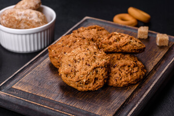 Tasty fresh oat cookies on a dark concrete background
