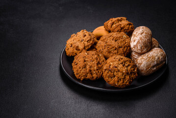 Tasty fresh oat cookies on a dark concrete background
