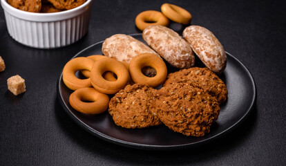 Tasty fresh oat cookies on a dark concrete background