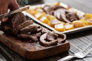 Carving of a rolled roast beef