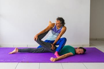 Thai Massage stretch for the quadriceps muscles (thigh and leg). Male massage therapist, female...