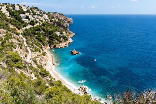 Views of the turquoise waters of Cala Ambolo on the Mediterranean Sea. Costa Blanca, Javea, Alicante, Spain.