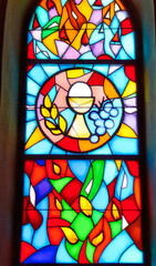 Decorative stained glass with motives from Christian religion used on windows in catholic church in...